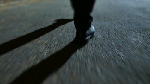 Young Man Walking on Street Alone in Dark Night