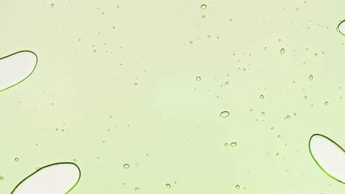 Transparent Green Cosmetic Gel Fluid With Molecule Bubbles and Oil on White Background Macro Shot