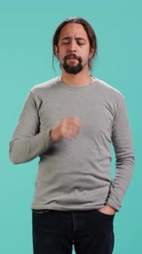 Man Pondering with Hand on Chin in Studio