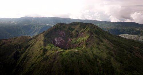 Mount Batur crater, active volcano on Bali island, Indonesia. Aerial drone panoramic view and sky fo