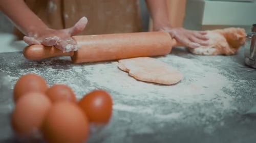 Young beautiful woman is baking in her kitchen