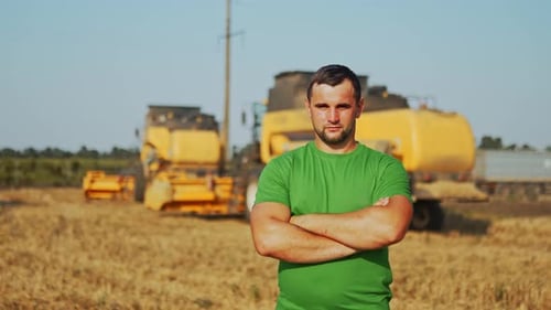 Portrait of Proud Harvester Machine Driver with Hands Crossing on Chest Farmer Standing at His