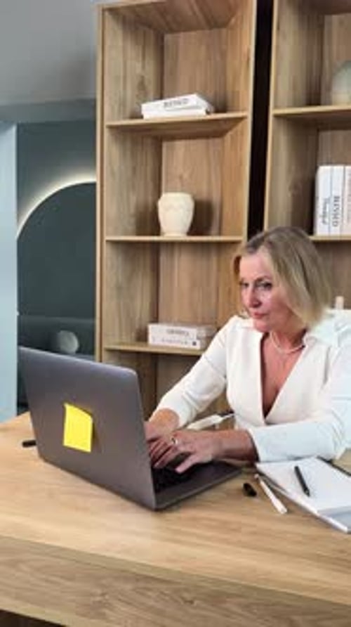 A Professional Woman Excelling in a Modern Office Environment Actively Engaged in Work