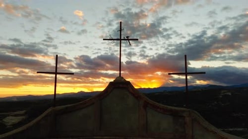 Silhouette of Three Christian Religious Crosses in Front of a Sunset Sky Symbol