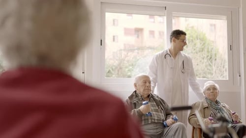 Senior People Exercising with Dumbbells in a Nursing Home