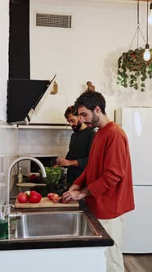 Two Friends Cook Together in Kitchen