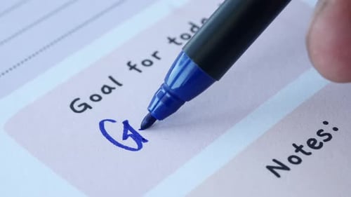 Goal Setting Using a Blue Marker on a Planning Sheet for Enhanced Clarity and Organization