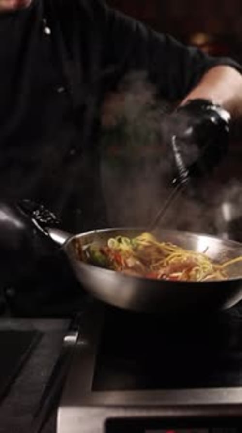 Chef Cooking Pasta with Vegetables in Pan