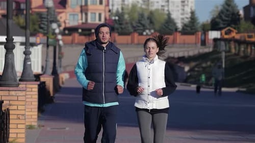 Couple Jogging Together in the City on a Crisp Autumn Morning