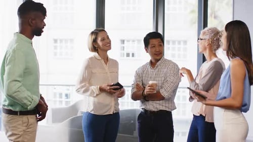 Discussing project ideas, diverse team collaborating in modern office setting