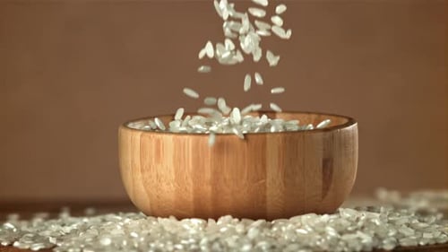The Rice Falls Into a Wooden Bowl Filmed on a Highspeed Camera at 1000 Fps