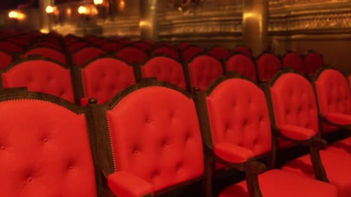 Empty Red Velvet Seats in Ornate Classical Theater