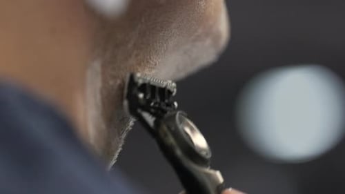 Closeup View of Unrecognizable Caucasian Man Shaving His Beard