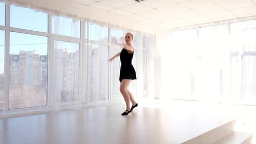 Elegant Woman Performs Ballet in Bright Studio