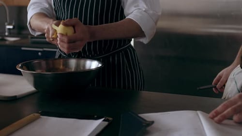 Chefs preparing food at kitchen work station