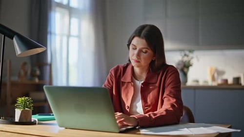 Woman Working at Laptop in Bright Home Office