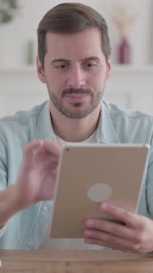 Young Man Reacting to Loss on Tablet in Office, Vertical Video