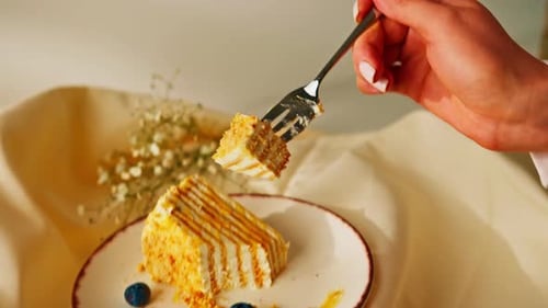 Woman Enjoying a Slice of Delicious Layered Cake