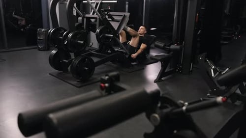 Man Doing Leg Press Exercise in Gym