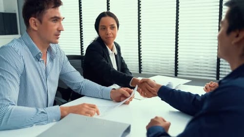 Business People Shaking Hands at Bright Office Meeting
