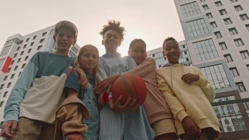 Group of Children Posing with Basketball in City