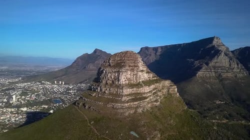 Flying towards Summit of Lions Head Mountain in Cape Town South Africa, Revealing Table Mountain and