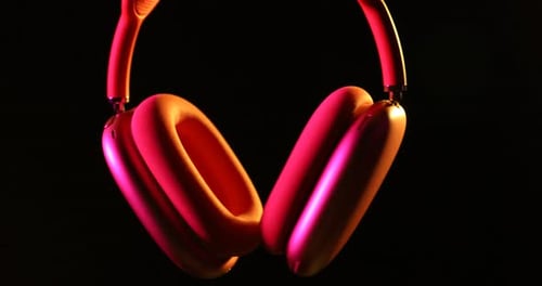 Wireless Headphones Rotating with Colorful Studio Lighting