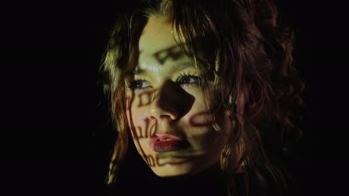 Portrait of a Woman with Light Pattern Across Her Face