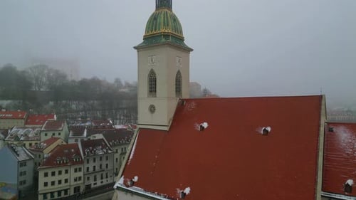 aerial drone view St. Martin's Cathedral rising above Bratislava during snowy winter day