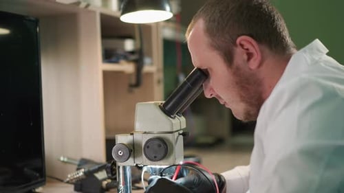 Scientist Using Microscope in Lab Workplace