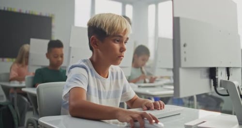 Young Boy Working on Creative Project on Computer Practicing Digital Skills and Studying Programming