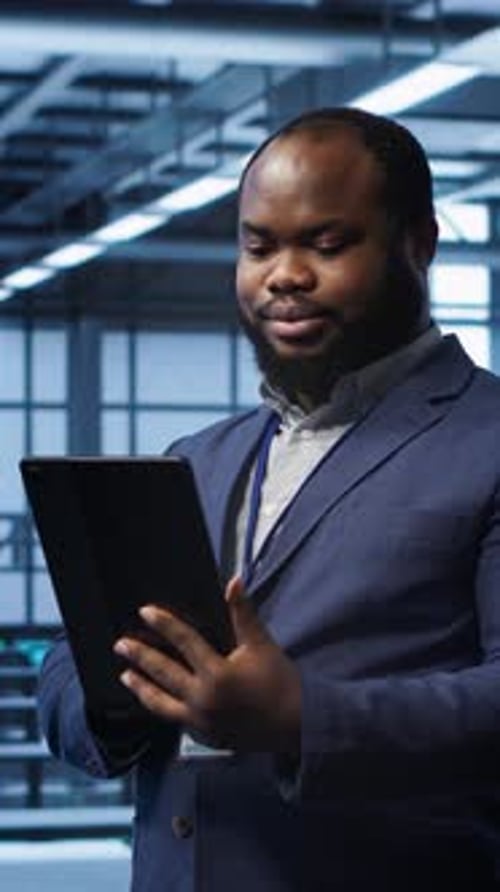 Man Using Tablet in Data Center Workplace