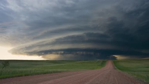 Rural Road Leading to Dramatic Storm Clouds