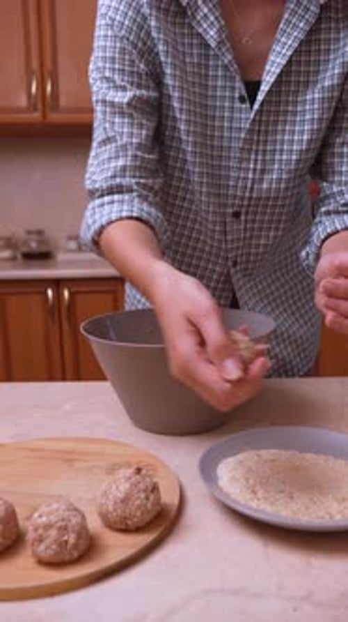 Woman Preparing Meatballs Breading in Kitchen