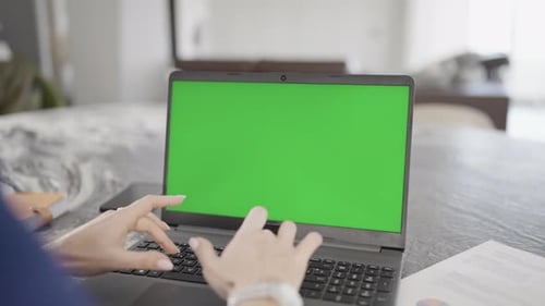 Dona Types on Laptop with Green Screen