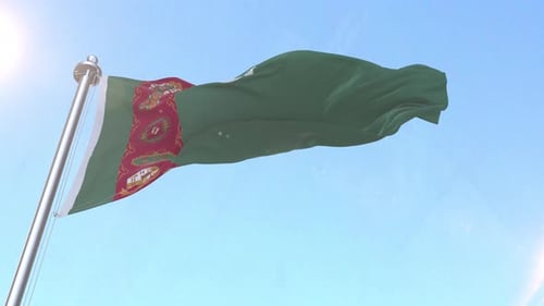 Turkmenistan Flag Waving in Wind Against Clear Blue Sky