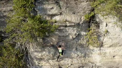 Girl Rock Climber Scaling an Outdoor Rock Wall Cliff - Adventure Sports - Extreme Sports - Action Sp
