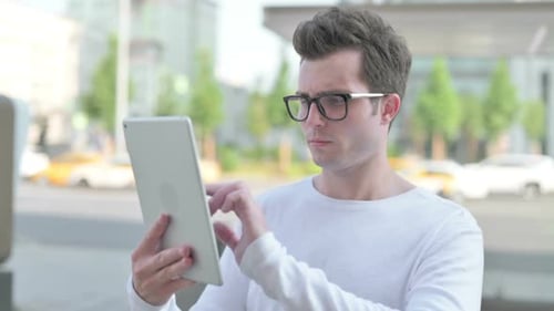 Young Man Using Digital Tablet Outdoor
