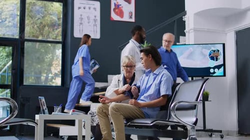 Doctor Checks Patient's Blood Pressure in Hospital