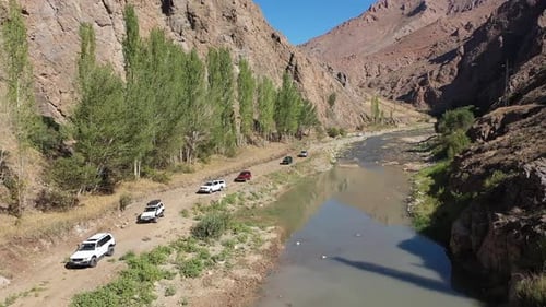 Aerial View Of Offroad Vehicles Driving By The Creek