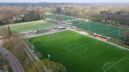 Jib up over large soccer fields at the edge of a small town