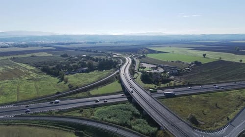 Bird's Eye View of an Asphalt Highway Passing Through Trees Growing in the Countryside and Around