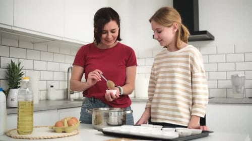 Woman and Teen Girl Baking in Kitchen
