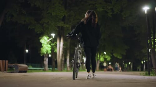 Serene Night Cycling Quiet Evening Scene With Thoughtful Cyclist And Soft Lighting Calm Urban Park