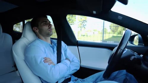 Male Businessperson Experience to Ride an Autonomous Self Driving Electric Car at Urban Road