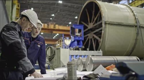 Workers at Factory Discuss Drawings Stock Clip Workers with Drawings on Factory Floor with Machines