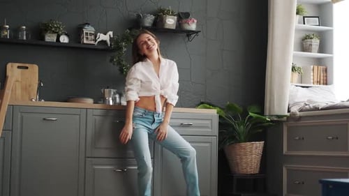 Woman Dancing and Flipping Hair in Kitchen
