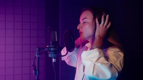 Emotional Woman Singer Recording a Track in Music Studio