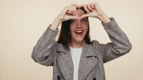 Young Woman Smiling Making Heart Shape