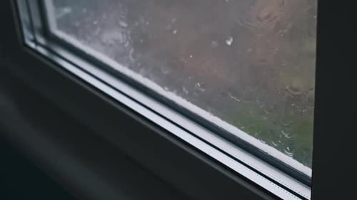Raindrops Streaking Down Window Pane